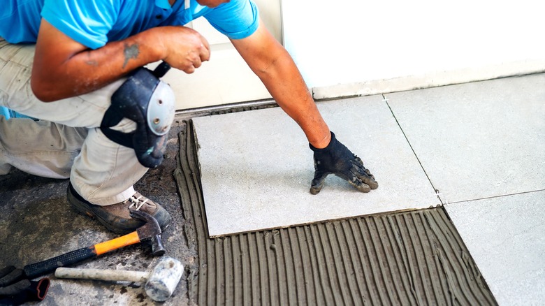 man installing porcelain floors