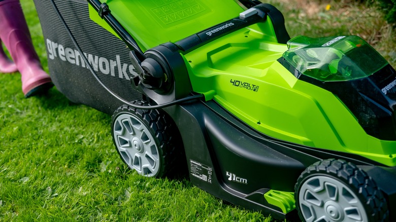 person pushing Greeenworks 40V mower