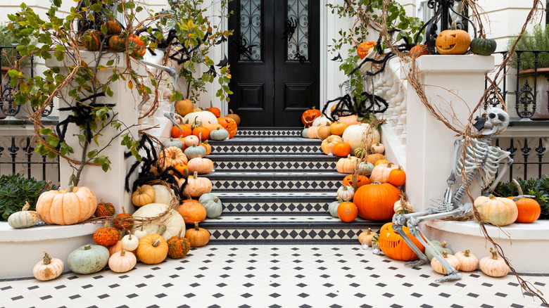 Assorted pumpkins on a home's front steps