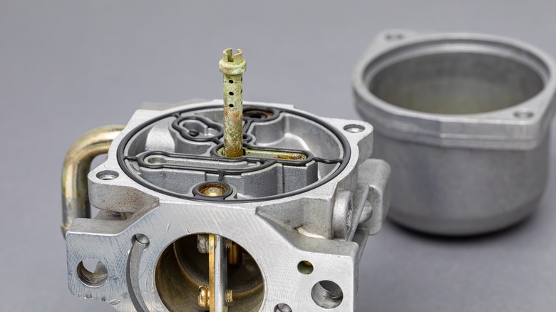 A partially disassembled carburetor in need of cleaning