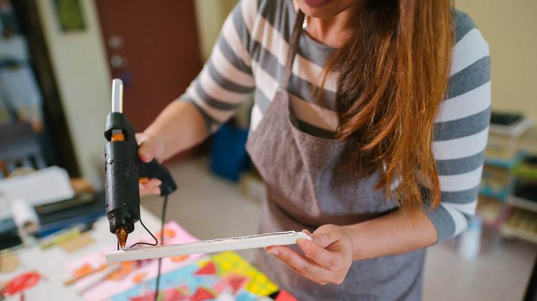 Woman working with a glue gun