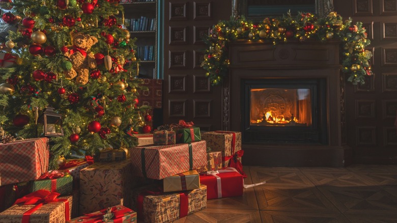 Traditional christmas decor with tree, mantel garland, and presents