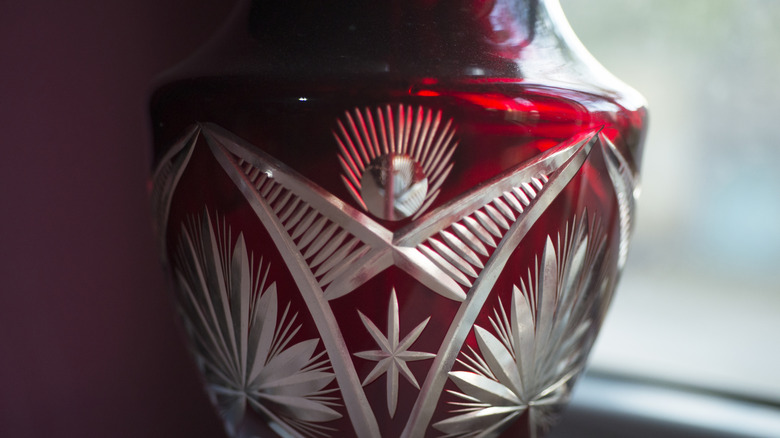 An etched ruby glass vase