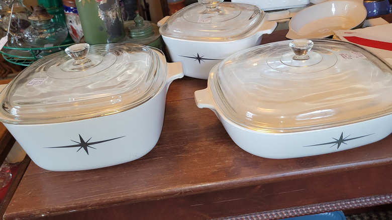 Rare Corningware cookware dishes from the 1950s to 1960s featuring the Atomic Starburst pattern on a shelf
