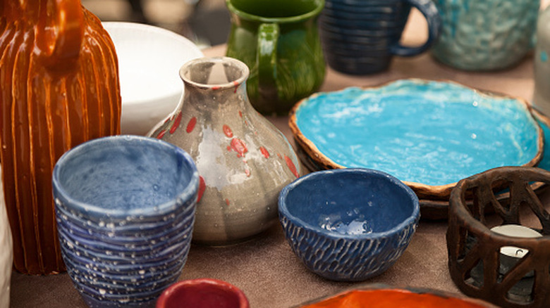 an assortment of pottery on a table
