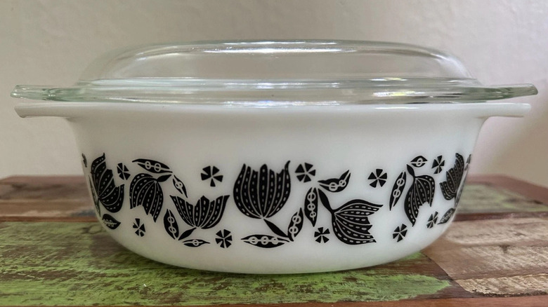 A Black Tulip Pyrex casserole dish with its lid
