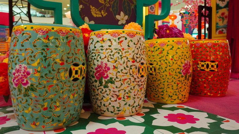 A set of four Chinese medallion garden stools in a store.