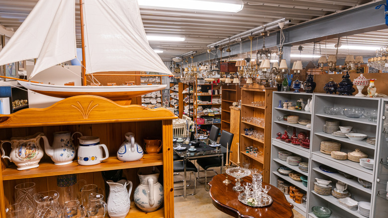Thrift store aisle with pottery and glassware