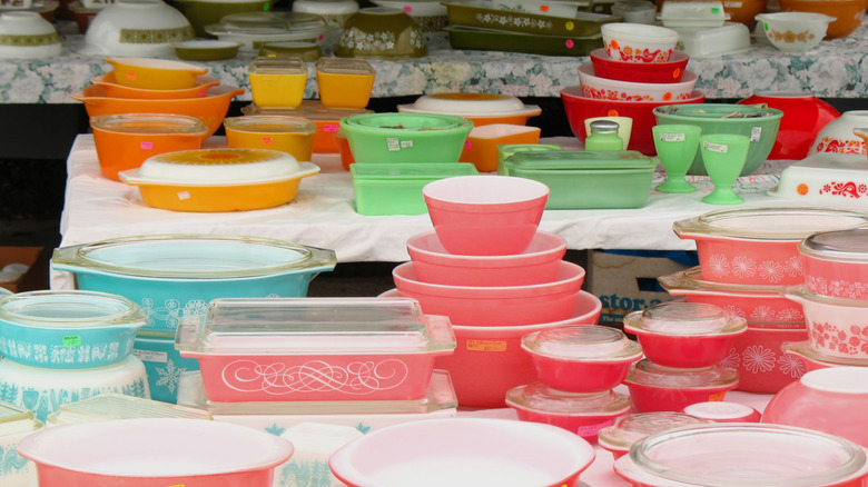 Variety of vintage Pyrex for sale on tables.