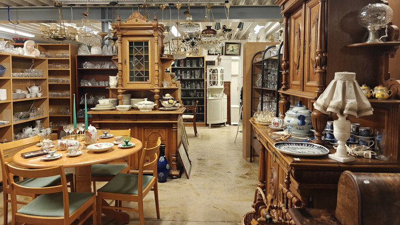 A tidy thrift store with furniture and dish displays