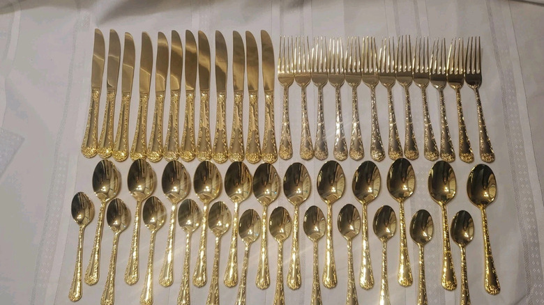 The WM Rogers Enchanted Rose silverware in gold plating.