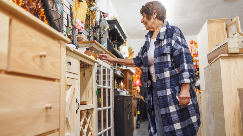 Woman shopping for furniture cabinets