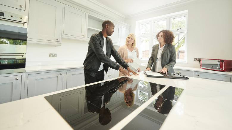 Real estate agent shower couple a kitchen with center island