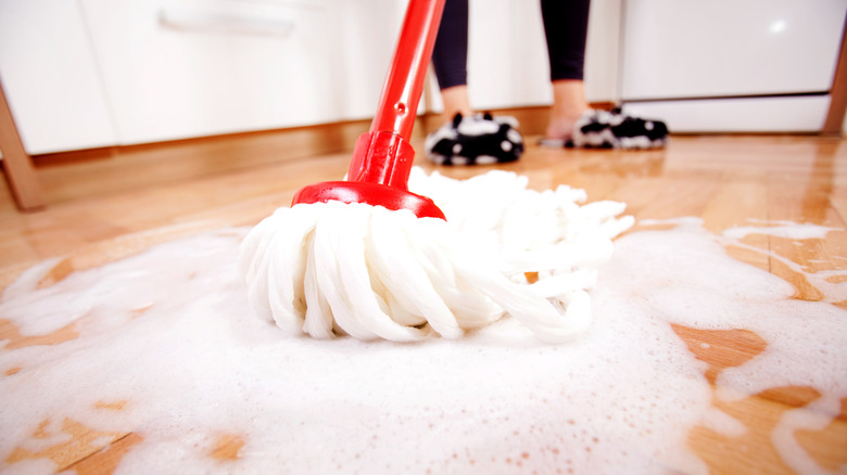 Person mopping floor with too much soap