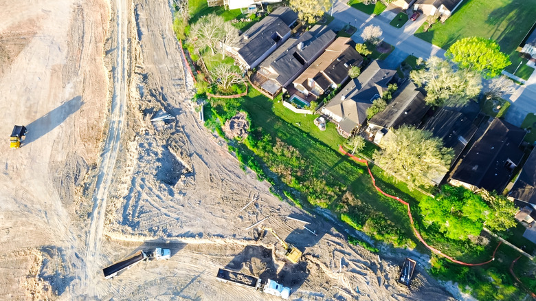 Overhead view of a construction project near an established neighborhood