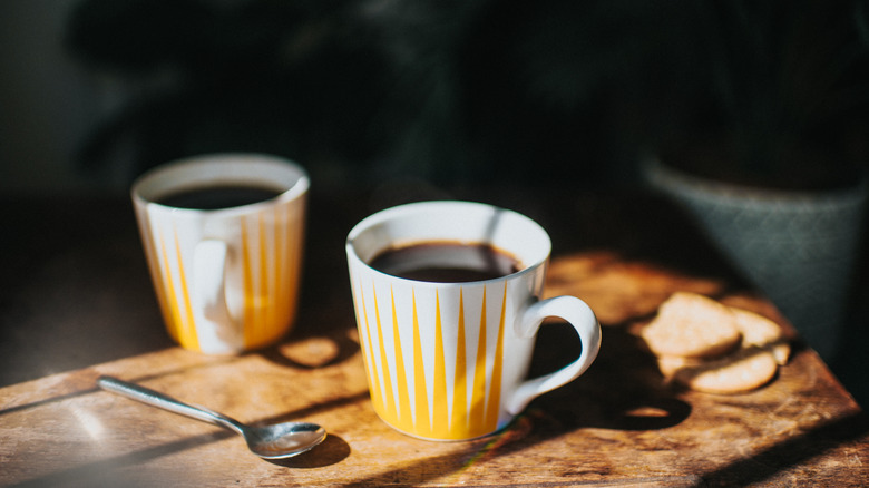 Two mugs and a coffee spoon