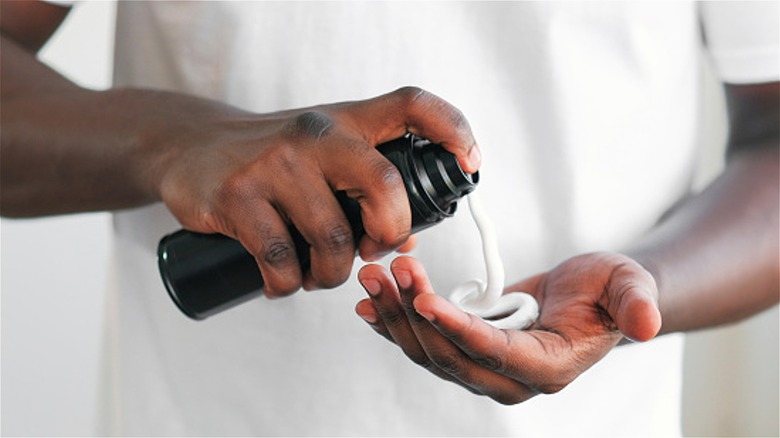 spraying shaving cream into hand