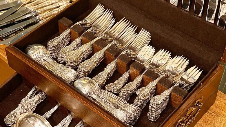 Collection of Francis I flatware of spoons, salad forks, and forks in a wooden box
