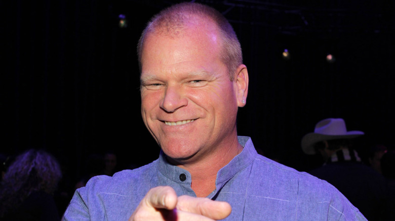 Mike Holmes smiling and pointing at the camera