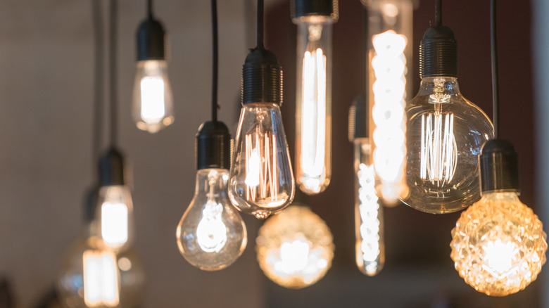 Various hanging pendant lights with lit bulbs