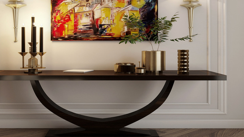 Two wireless sconces on either side of a painting
