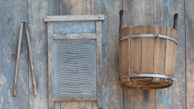 an old washboard, bucket, and washing paddle