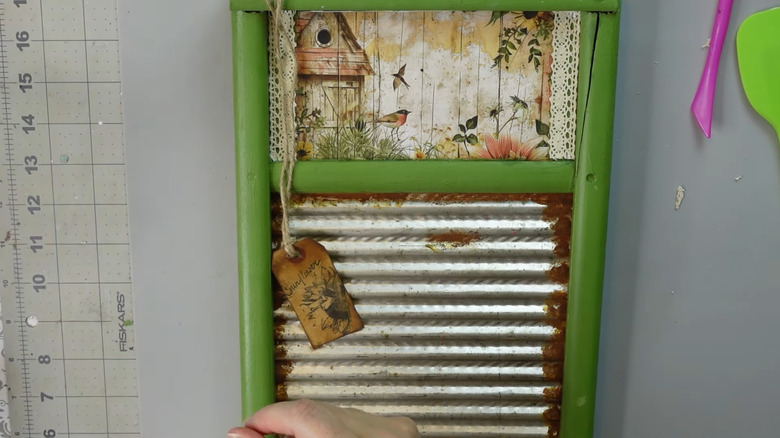 an old washboard with added decoupage botanical designs and green paint