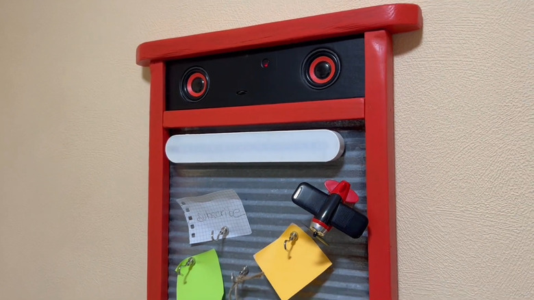 old washboard transformed into a robot-looking digital message board