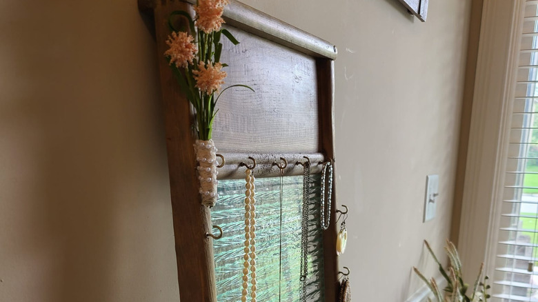a vintage washboard repurposed as a jewelry organizer