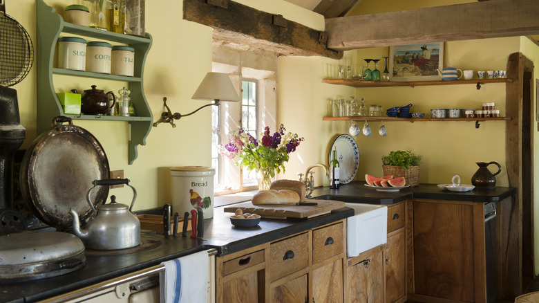 Cottagecore kitchen with wood cabinets and yellow walls