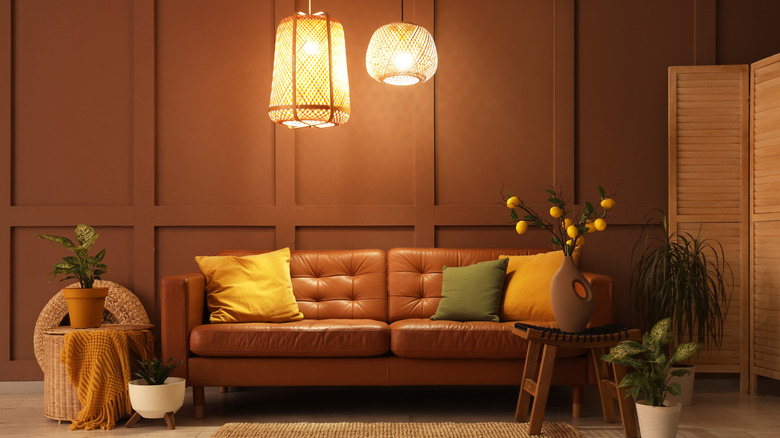Warm, cozy living room with leather couch and soft pendant lighting