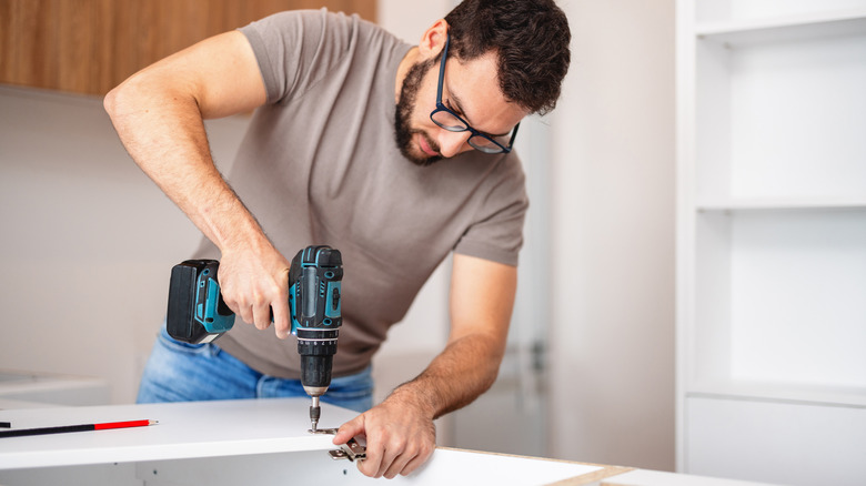 A man using a cordless power drill