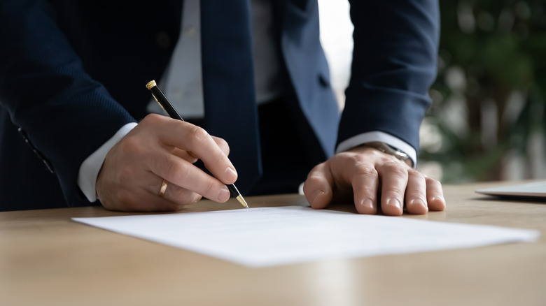 Hand signing a document
