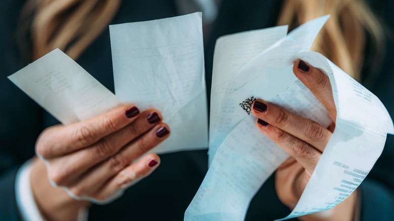 Hands holding receipts