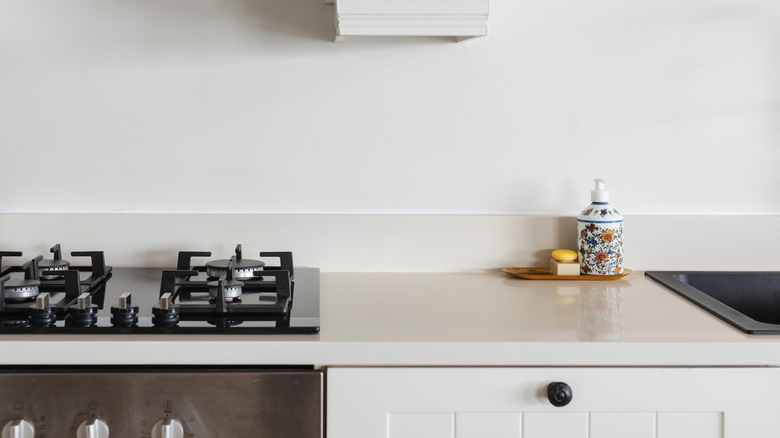 kitchen with white quartz countertop and white cabinets
