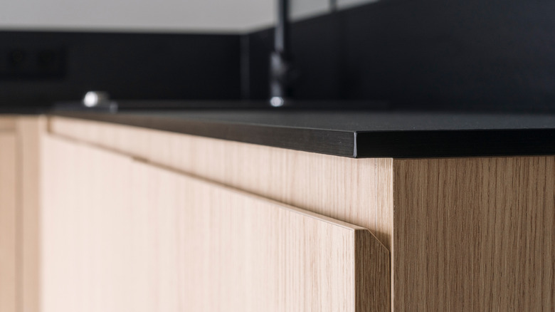 black quartz countertop over wood cabinets