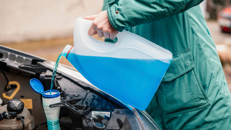 Pouring a jug of antifreeze