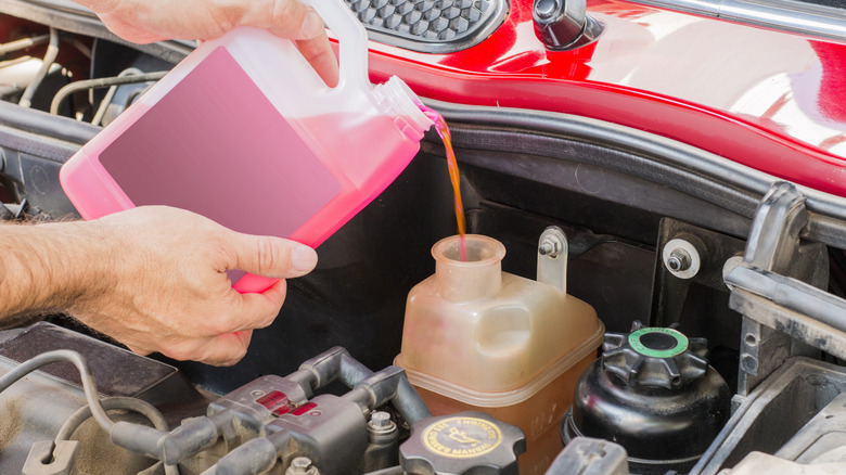 pouring brake fluid in tank