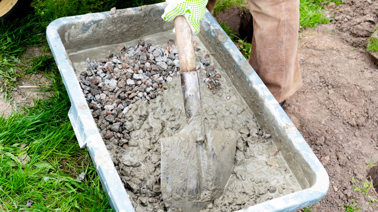 Person mixing wet concrete