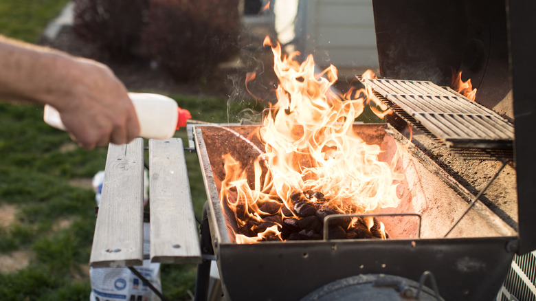 Using lighter fluid on grill