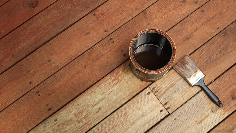 Can of wood stain on deck