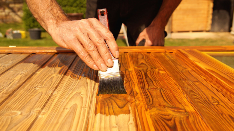 Person applying wood stain