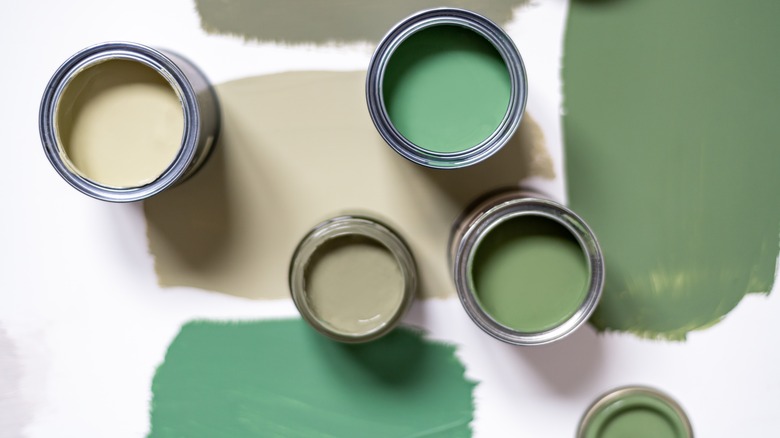multiple cans of green paint
