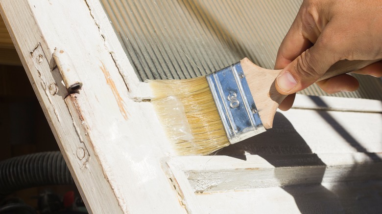 Man applies gel paint stripper