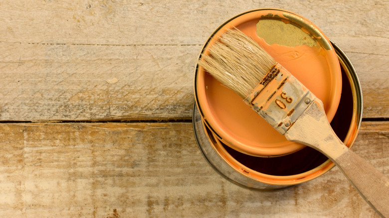 Oil paint can and brush