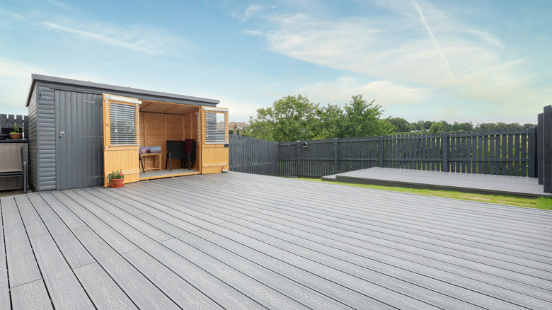 A deck and shed made of composite materials in a residential backyard.