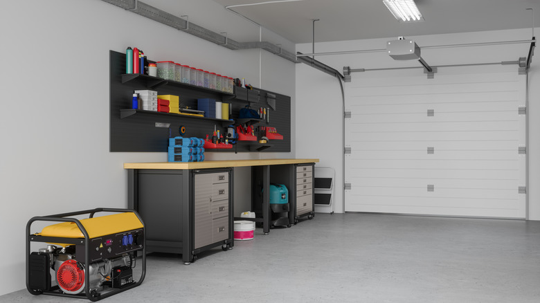 Inside a garage with lots of space for a car and a work bench