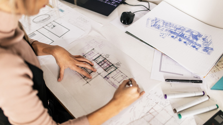 A woman with architectural drawings