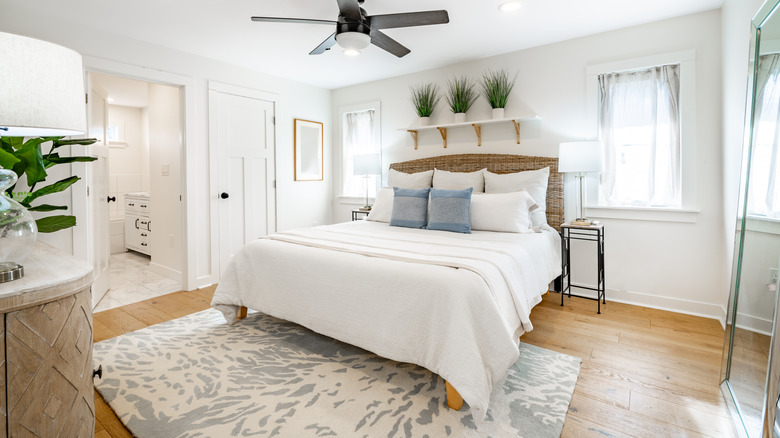 White bedroom with gray accents and printed rug