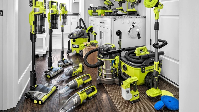 Collection of Ryobi handheld, stick, and wet/dry vacuums inside a modern home